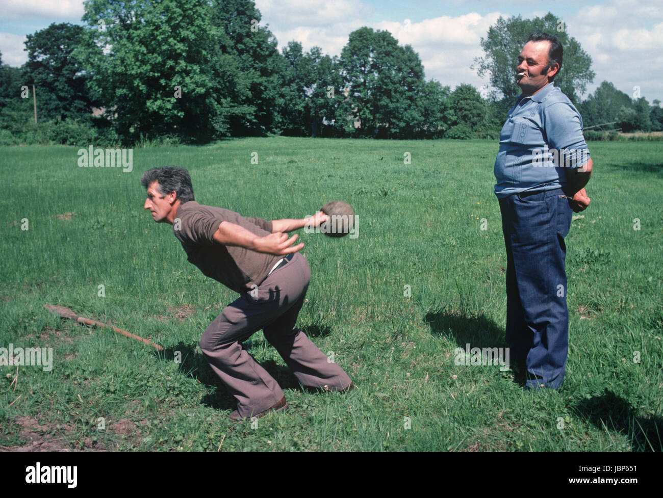 The throwing of a heavy metal ball game at Village St Clair Fete, Normandy, France Stock Photo