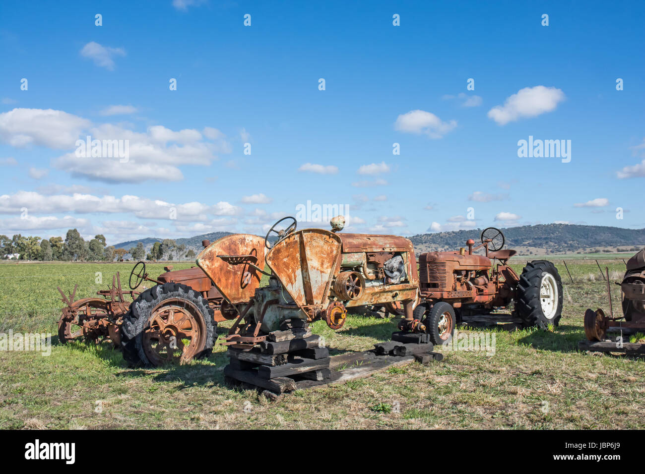 Rusty Old Farm Tractors in a Rural Paddock. Stock Photo
