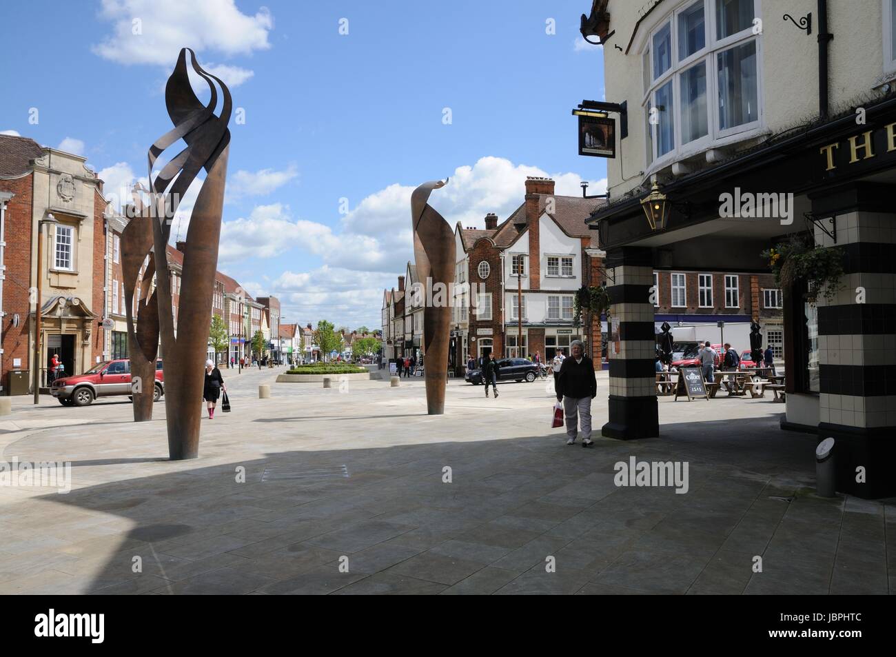 View past The Colonnade and modern sculpture in Station Place, Letchworth Garden City, Hertfordshire, towards Leys Avenue. Stock Photo