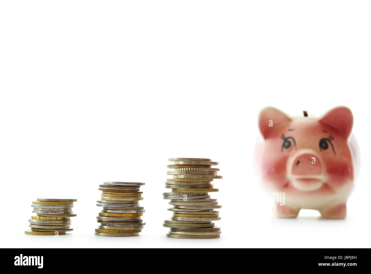 Pink piggy bank isolated on white background with coins Stock Photo - Alamy