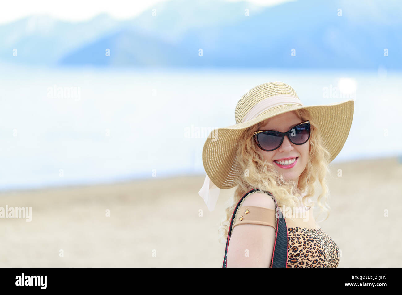 Beautiful blonde on the beach with hat and sunglasses in vacation Stock ...