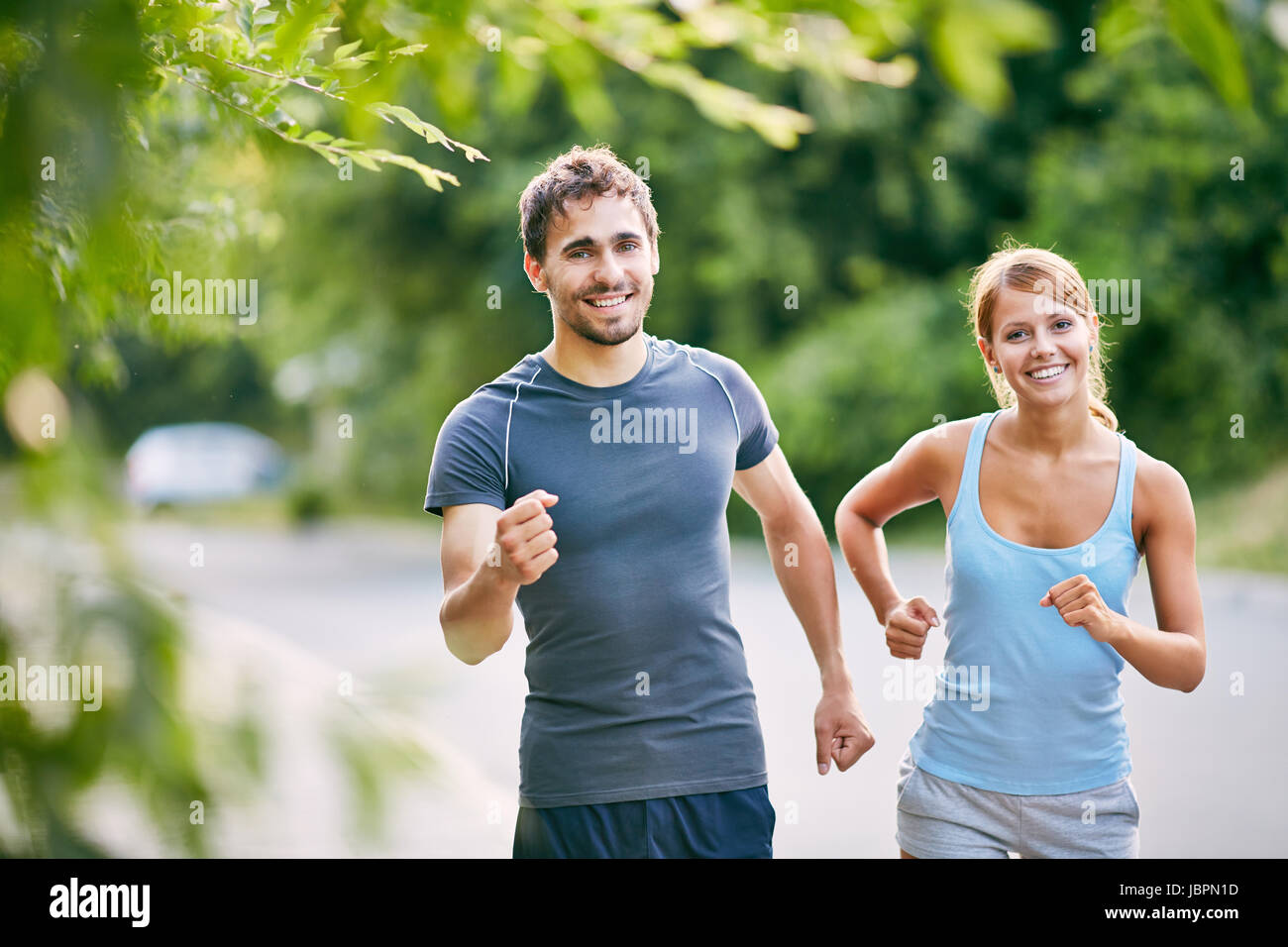 Photo of happy couple running in the morning outdoors Stock Photo - Alamy
