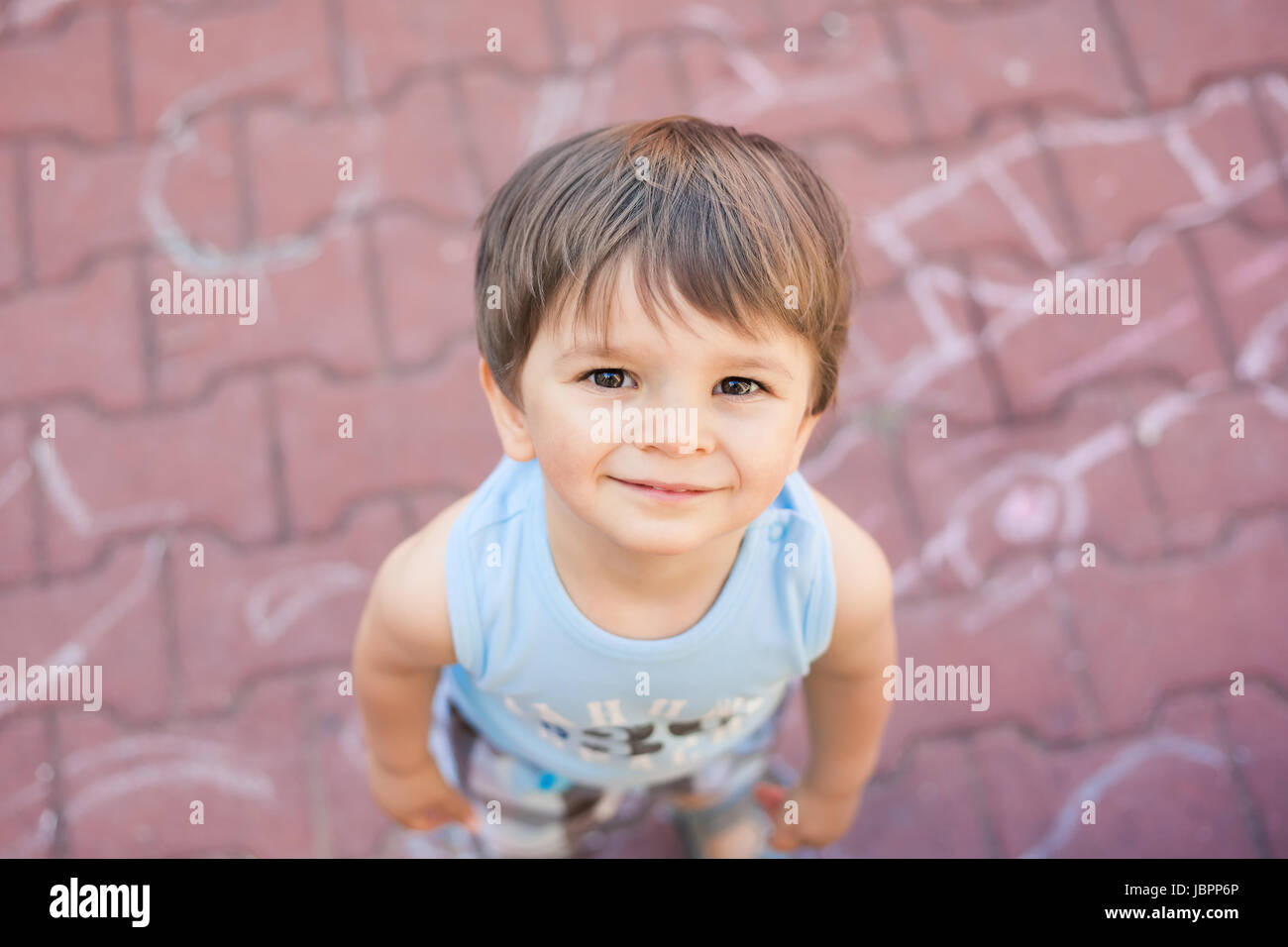 smiling small boy looking up at camera Stock Photo - Alamy