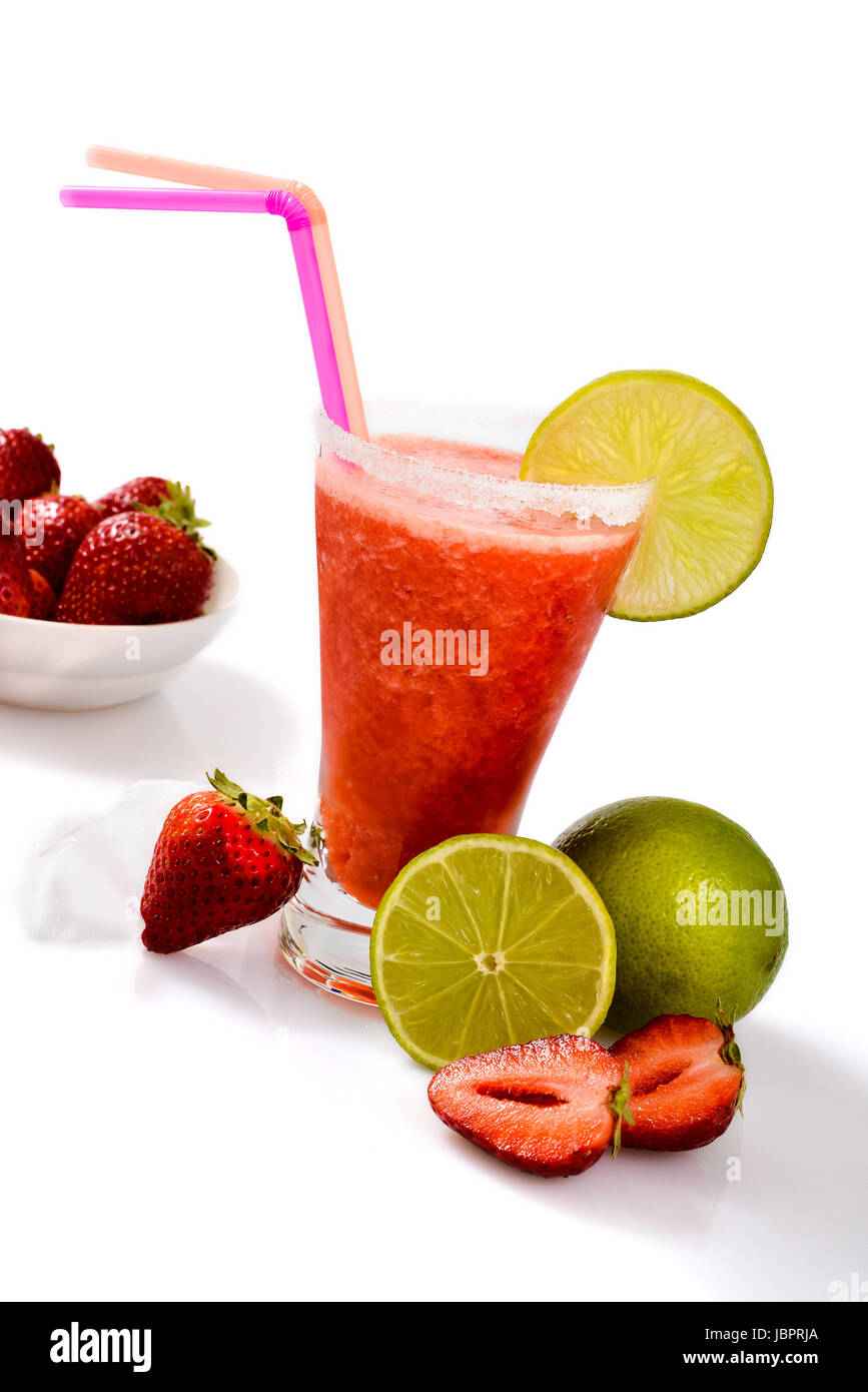 Frozen strawberry margarita isolated on a white background garnished with a salt rim and a lime wheel. Stock Photo