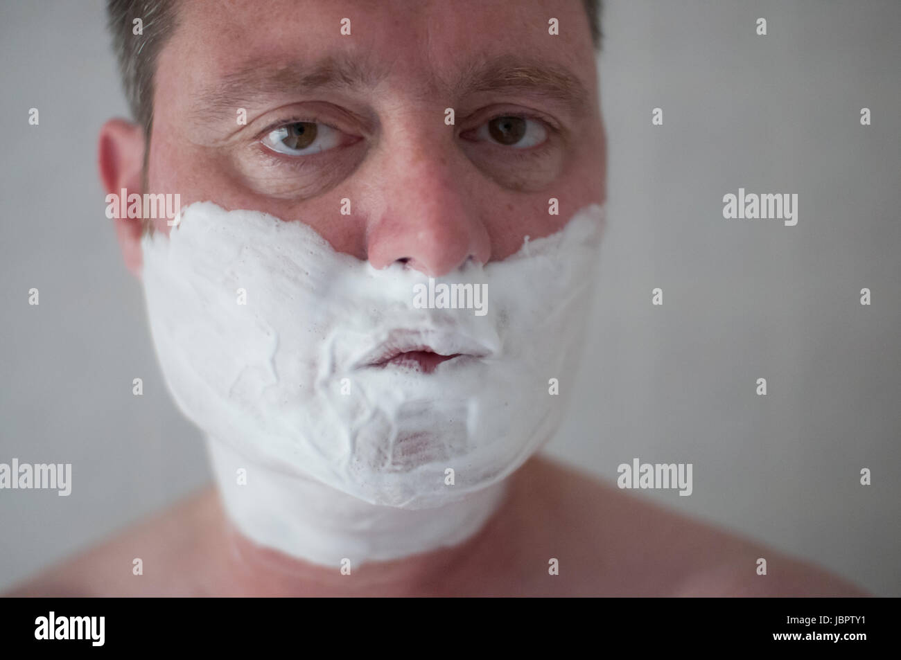 man with shaving cream on his face Stock Photo Alamy