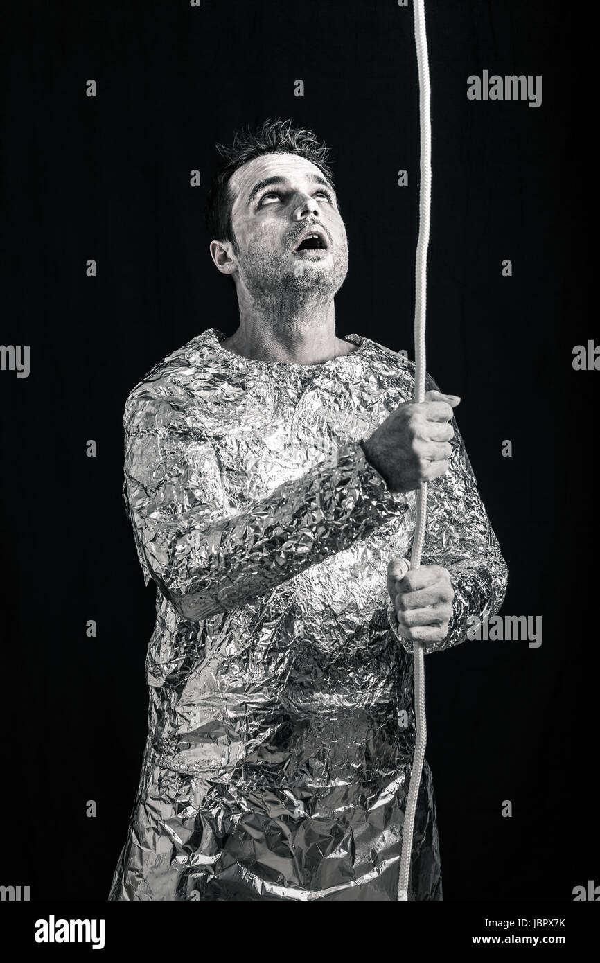 Surprised spaceman holding rope and looking up Stock Photo - Alamy