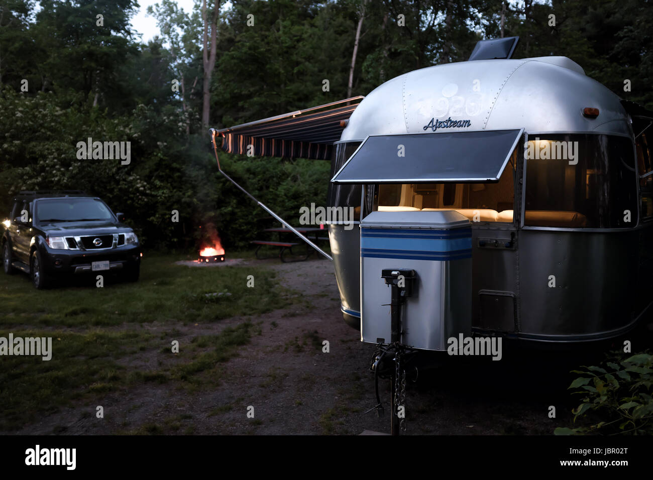 The iconic American made Airstream travel trailer sits in at a campsite in Southwestern Ontario Canada. Airstream was founded in the late 1920s. Stock Photo