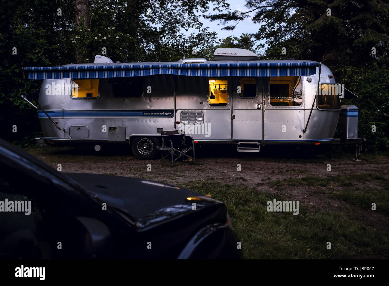 The iconic American made Airstream travel trailer sits in at a campsite in Southwestern Ontario Canada. Airstream was founded in the late 1920s. Stock Photo