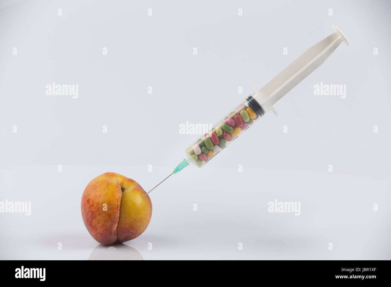 Female menopause and sexual disease metaphor peach and syringe with