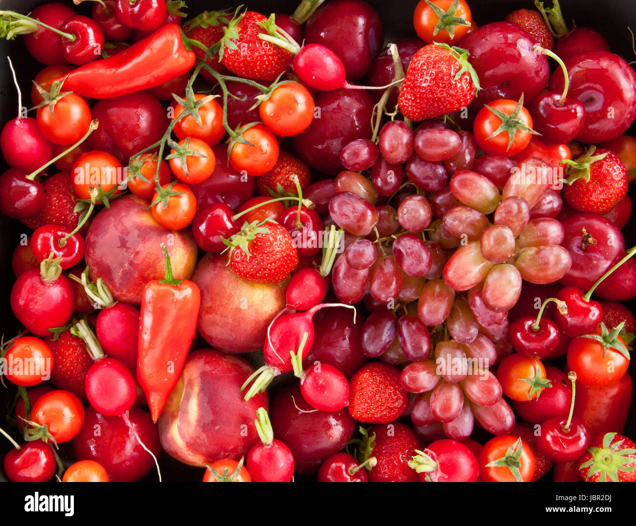 Frische rote Fruechte und Gemuese als Hintergund Stock Photo