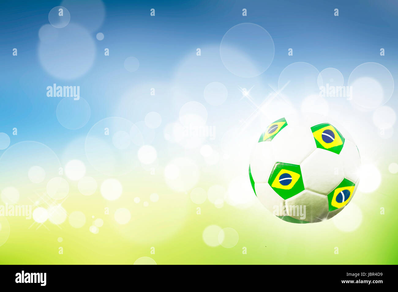 Soccer ball on blue, yellow and green background representing the