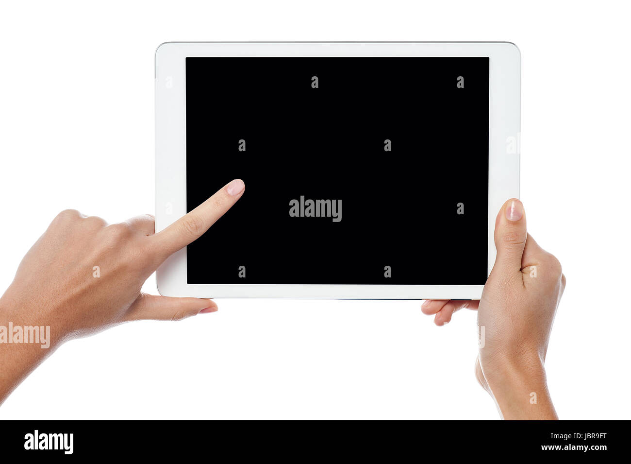Womans finger pointing on tablet screen Stock Photo