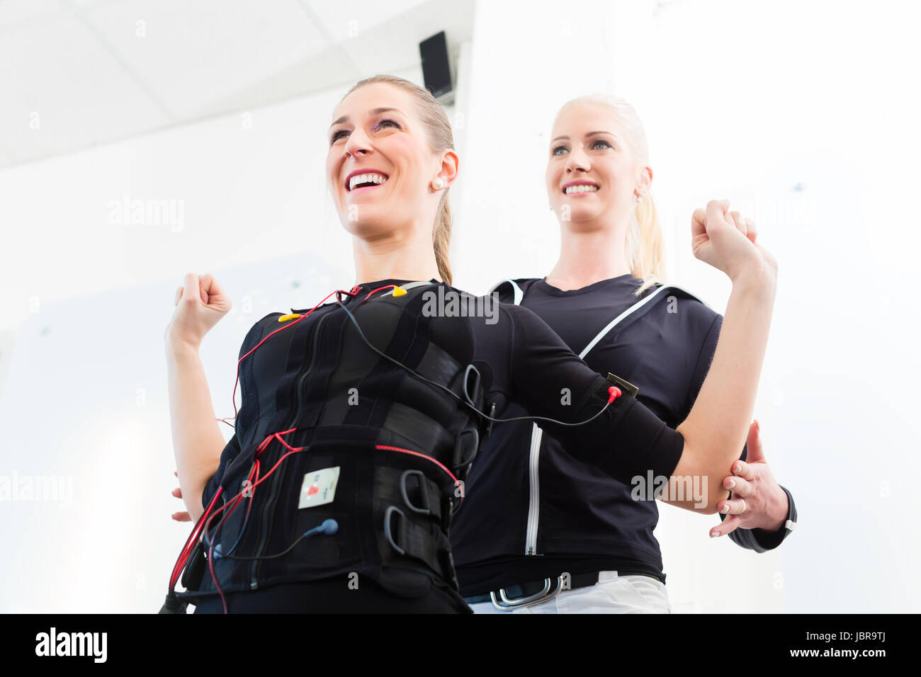 EMS Electro Stimulation Women Exercises with Coach in Modern Gym Stock  Image - Image of fitness, personal: 147937565