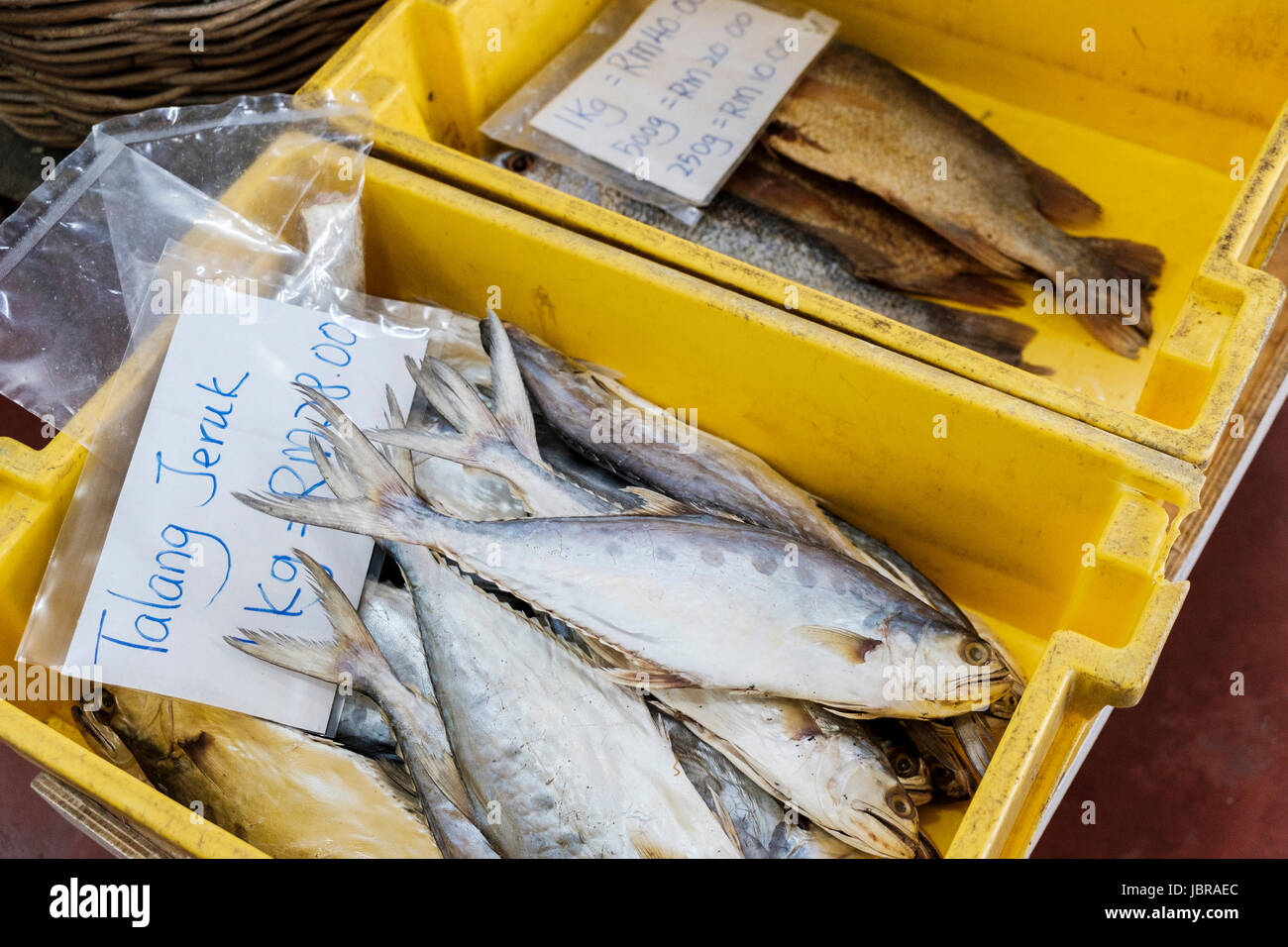 Two crates of fish for sale with prices in Malaysian ringgit at a
