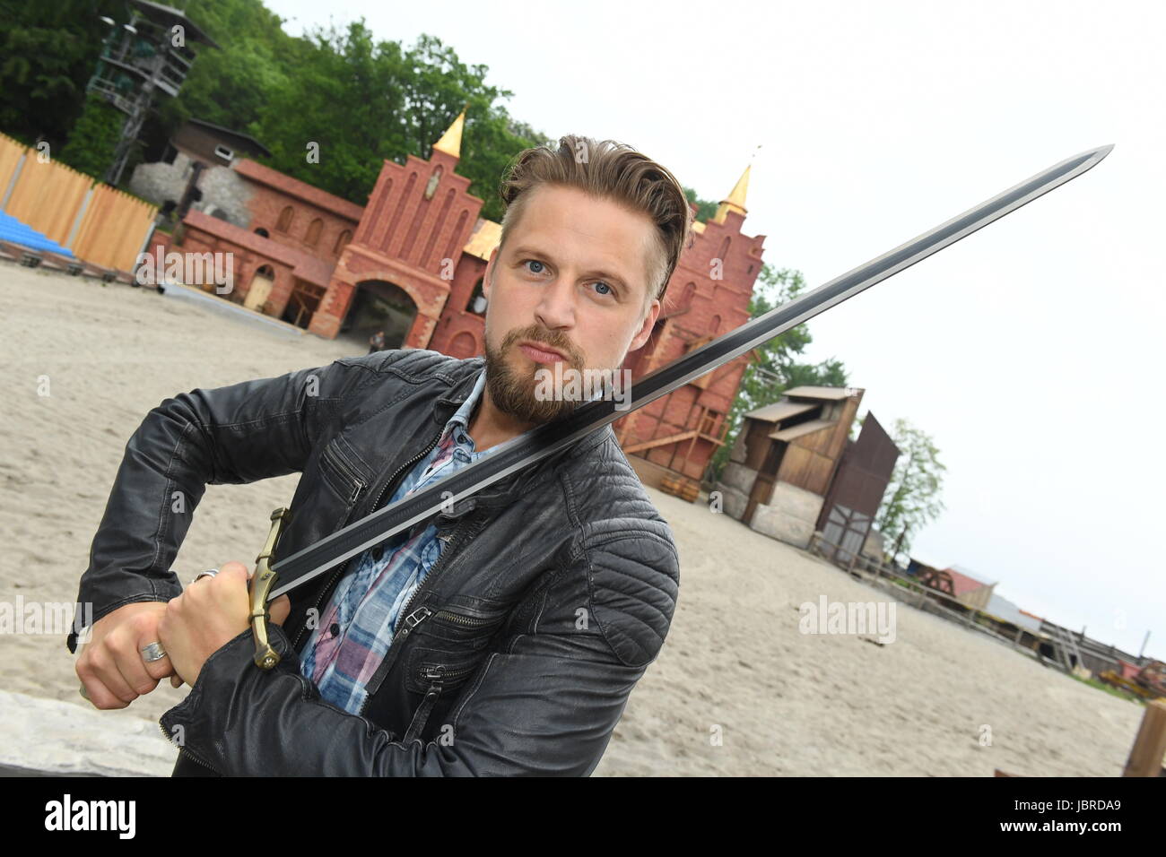 The actor of the pirate Klaus Stoertebeker, Bastian Semm, stands with a sword at the Nature Stage Ralswiek, Germany, 30 May 2017. The Stoertebeker Festival has been taking place for 25 years on the island of Ruegen. Photo: Stefan Sauer/dpa-Zentralbild/dpa Stock Photo