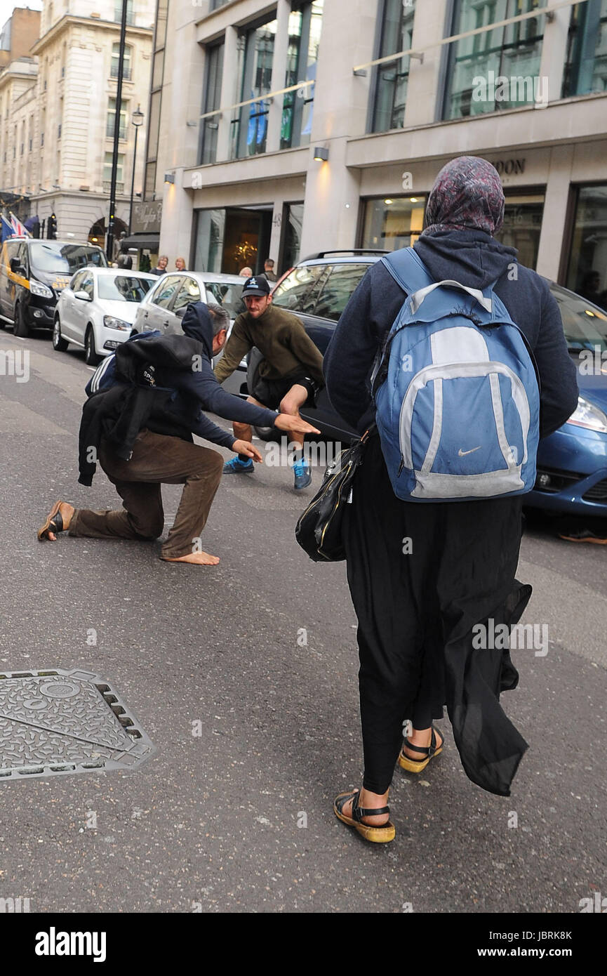 London, UK. 11th June, 2017. Beggars fight in Dover Street. London, UK. 11th June, 2017. Credit: Alamy Live News Stock Photo