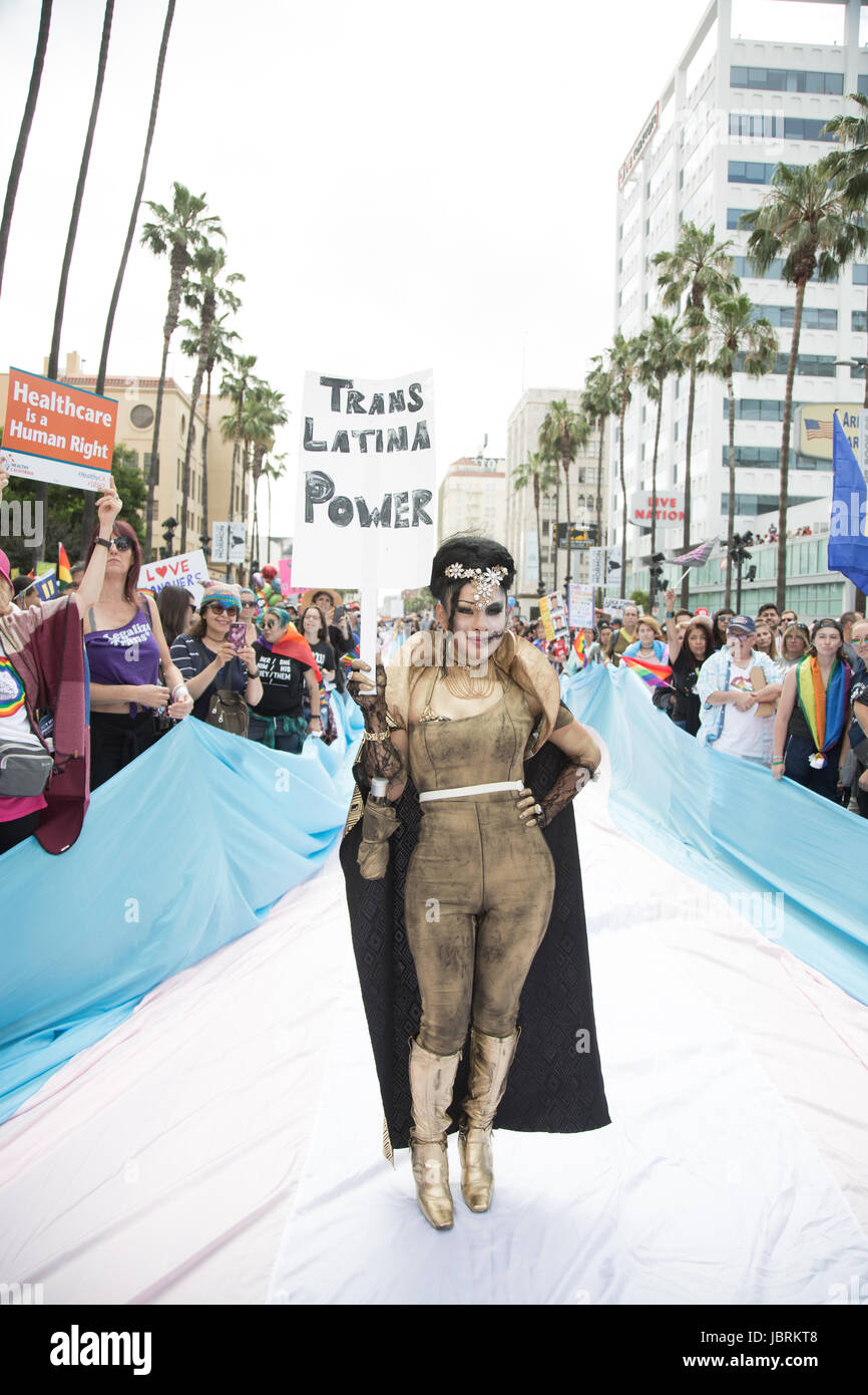 Los Angeles, California, USA. 11th June, 2017.  A march participant poses on the large flag represetning transgender rights at the L.A. Pride #ResistMarch in Los Angeles, Califormia on June 11th, 2017. Credit:  Sheri Determan/Alamy Live News Stock Photo