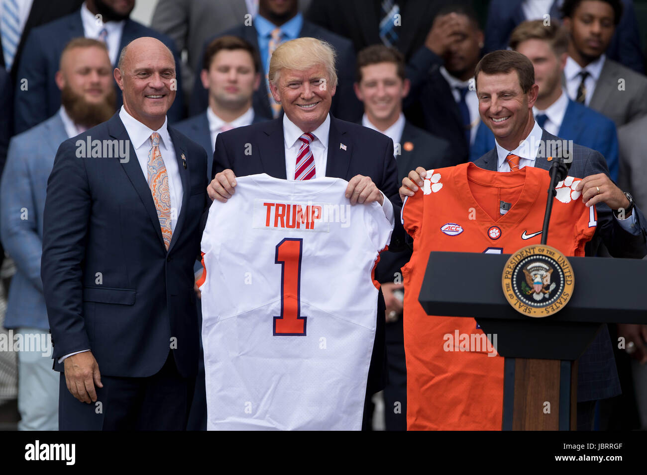 Washington, DC, USA. 12th June, 2017. U.S. President Donald Trump poses with football jerseys during a ceremony honoring the 2016 NCAA Football National Champions Clemson University Tigers at the White House in Washington, DC, the United States, on June 12, 2017. Credit: Ting Shen/Xinhua/Alamy Live News Stock Photo