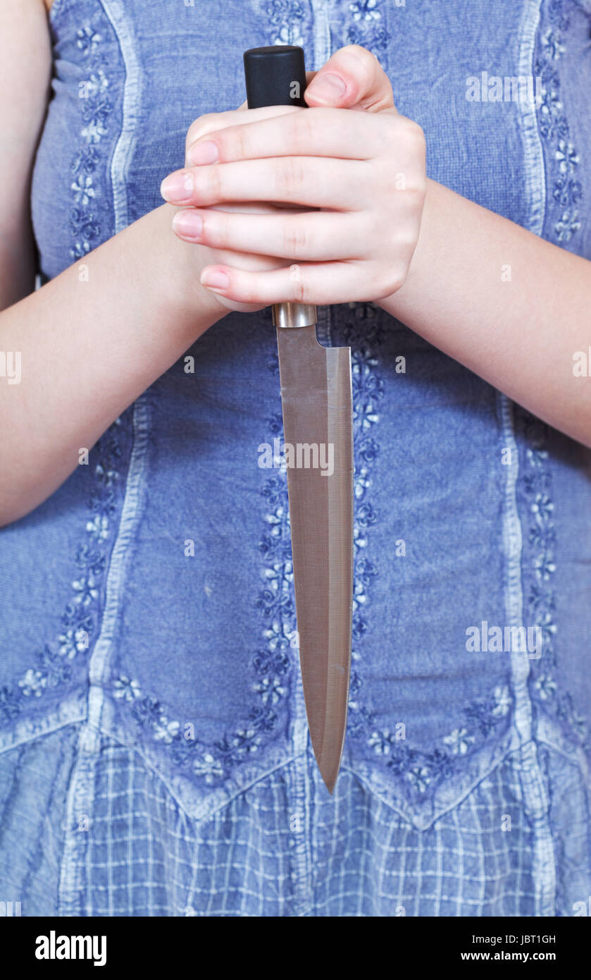 woman holding large kitchen knife by two hands Stock Photo - Alamy