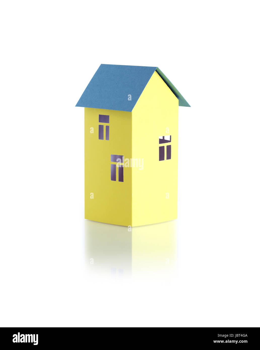 Nice yellow paper house with green roof on white background with