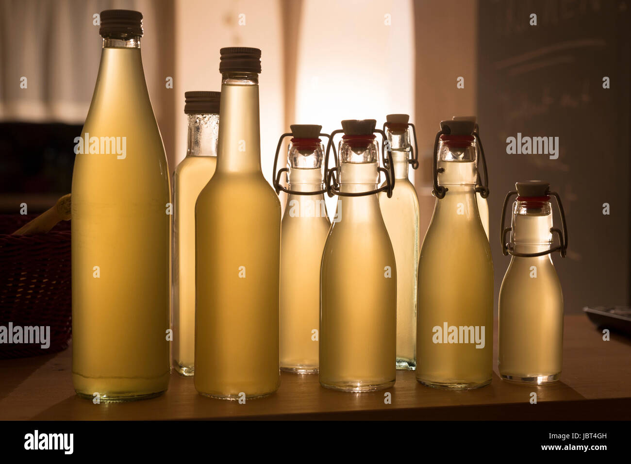 Flaschen mit Holundersirup gefüllt im Gegenlicht Stock Photo