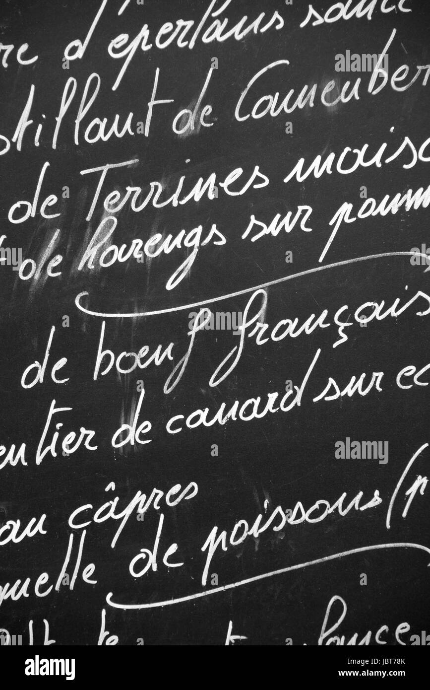 Close up of a French restaurant menu written with chalks on blackboard, Paris France - French cuisine, France travel and tourism concept Stock Photo