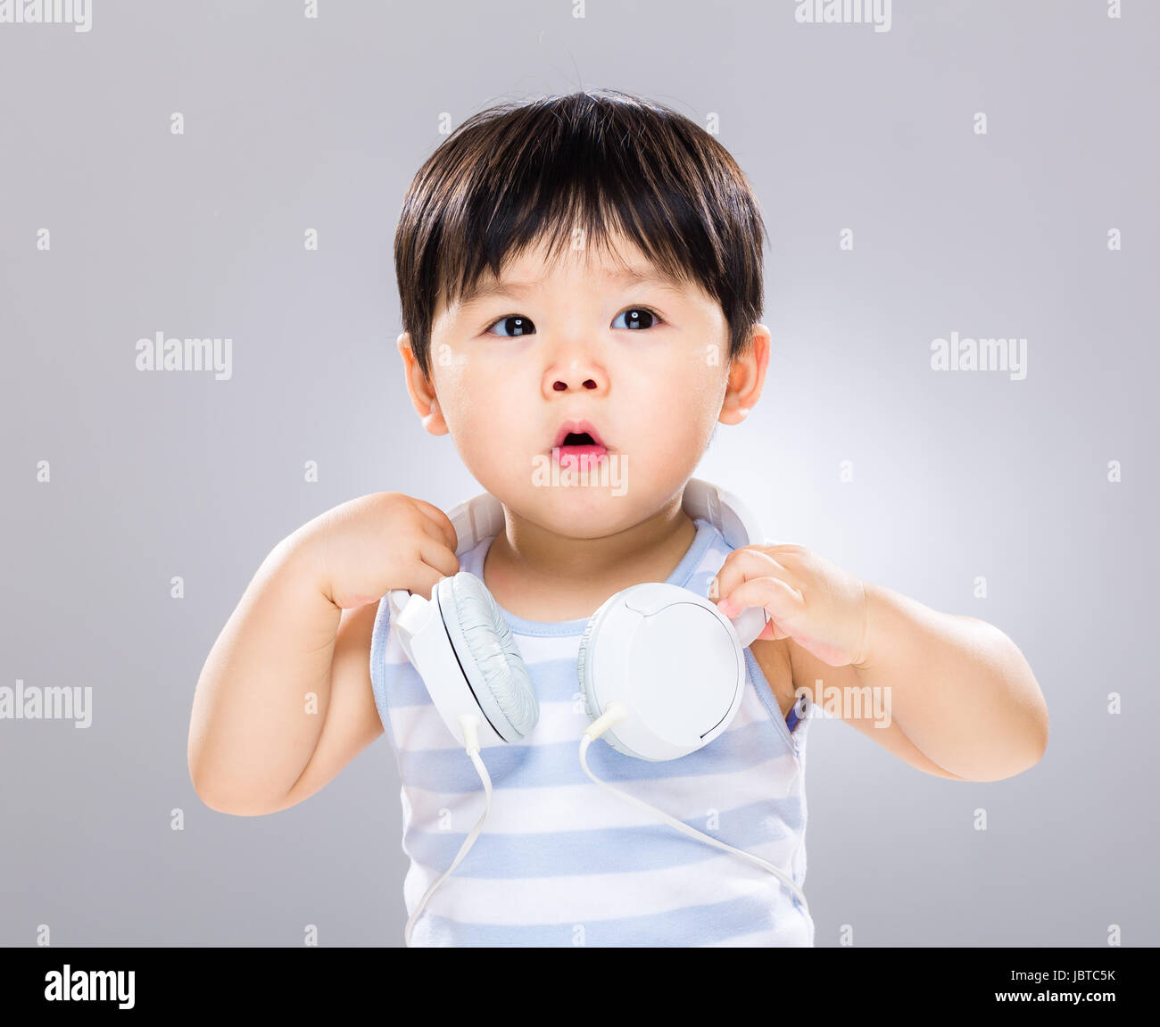Baby boy listen to music Stock Photo Alamy