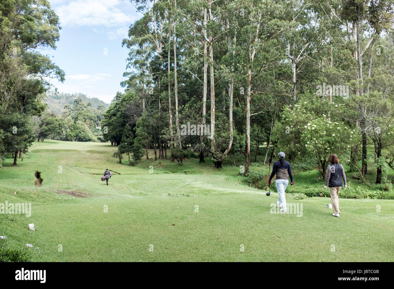 Players and caddies on the golf course at Nuwara Eliya, Sri Lanka Stock Photo