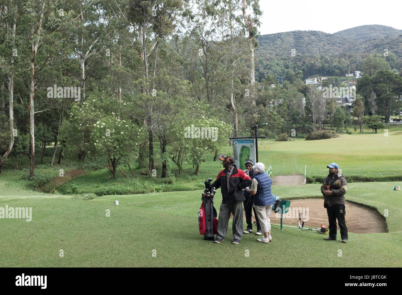 Players and caddies on the golf course at Nuwara Eliya, Sri Lanka Stock