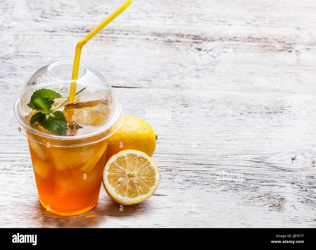 Plastic glass of lemon ice tea Stock Photo - Alamy