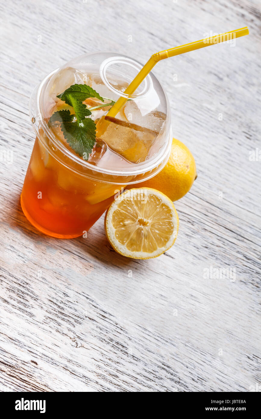 Iced tea in plastic cup with lemon and mint Stock Photo - Alamy