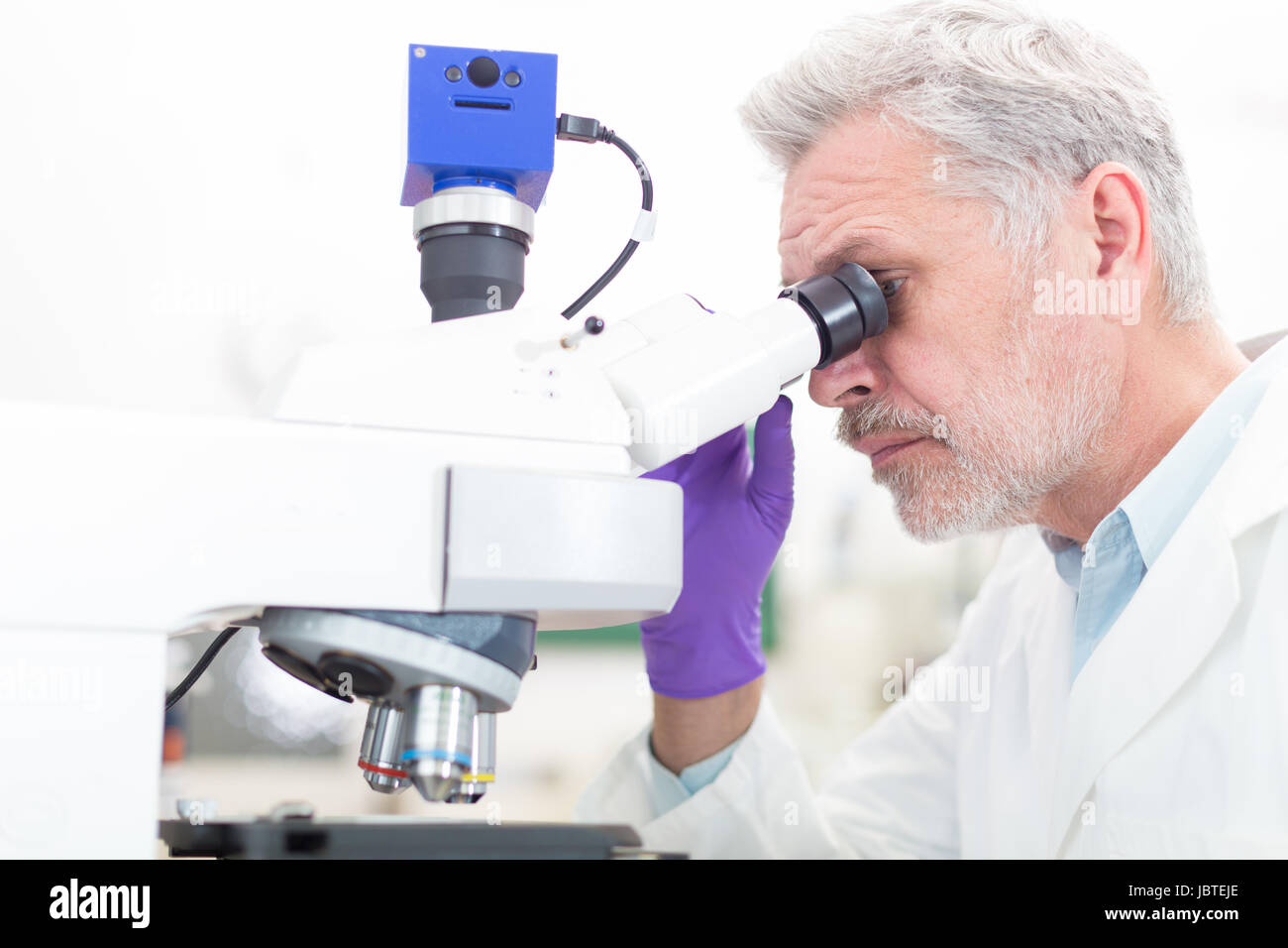Senior head scientist microscoping in the life science research