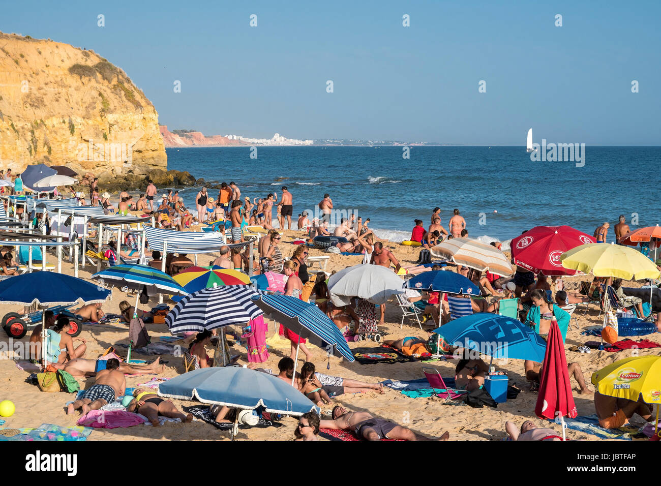 Europe, Portugal, Algarve, beach lying on the beach of Olhos de Agua