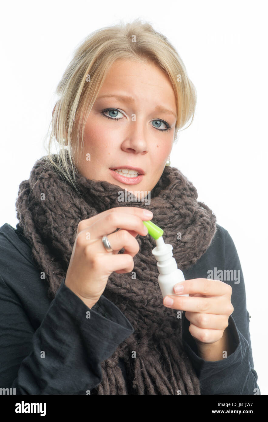 a cold woman with nasal spray Stock Photo