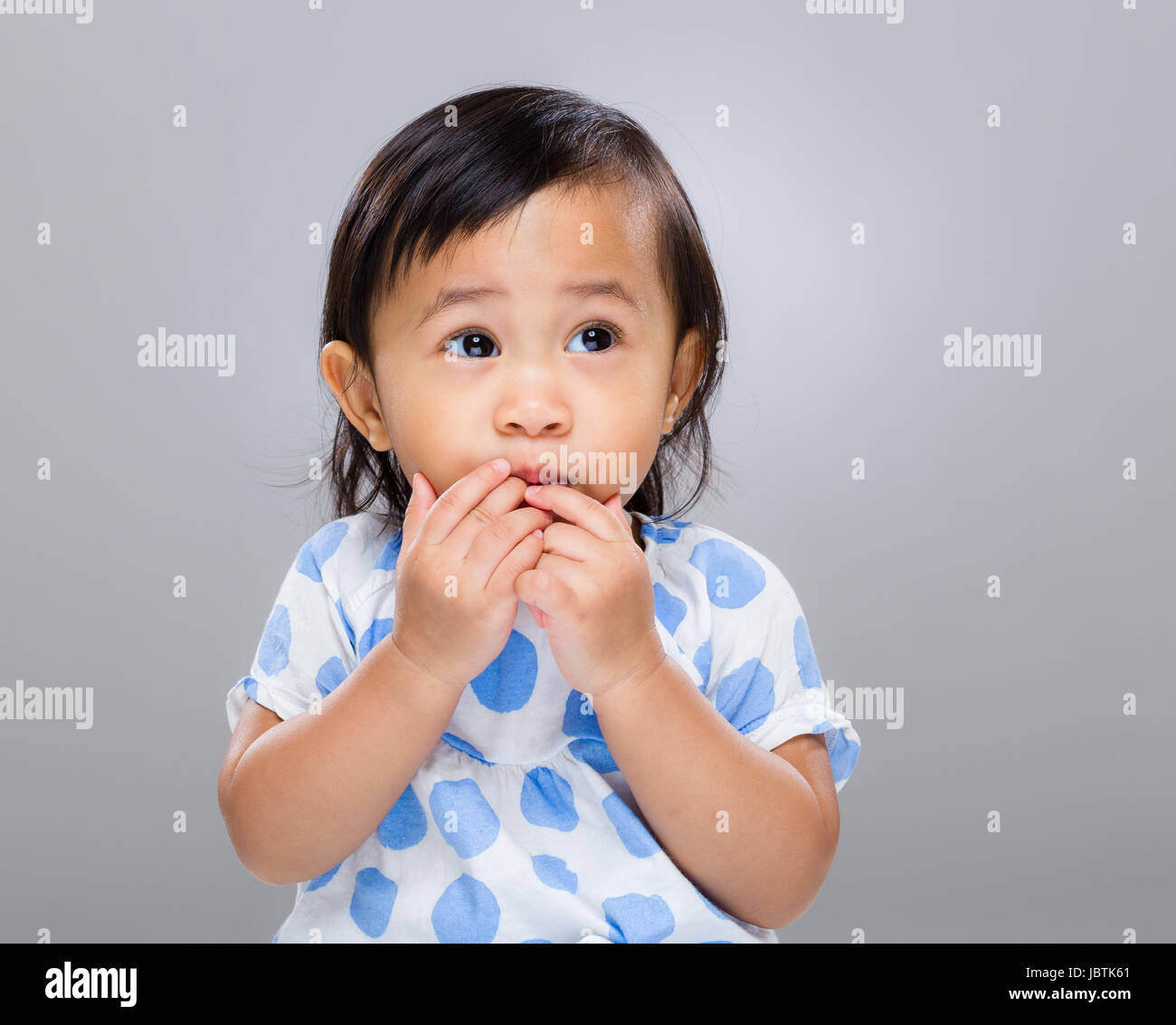 Little girl put finger into mouth Stock Photo Alamy