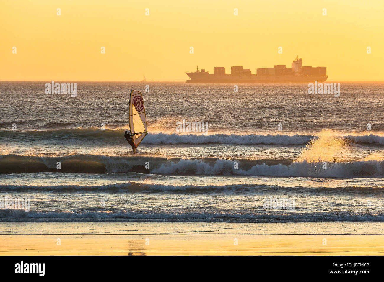 Kitesurfer surfing in the sunset on beach in Cape Town Stock Photo