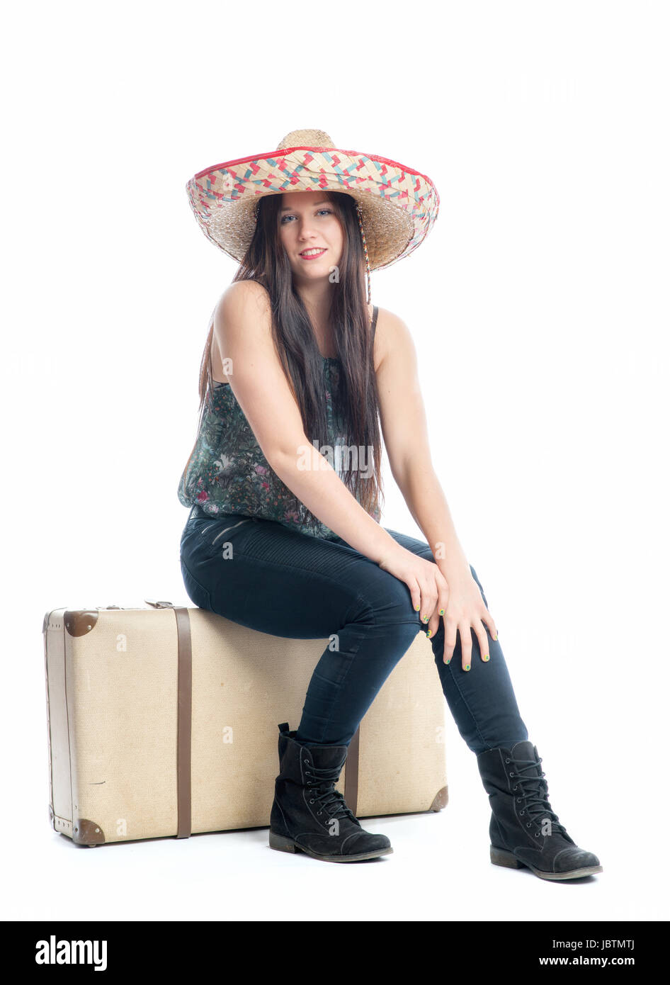 girl sitting on suitcase Stock Photo