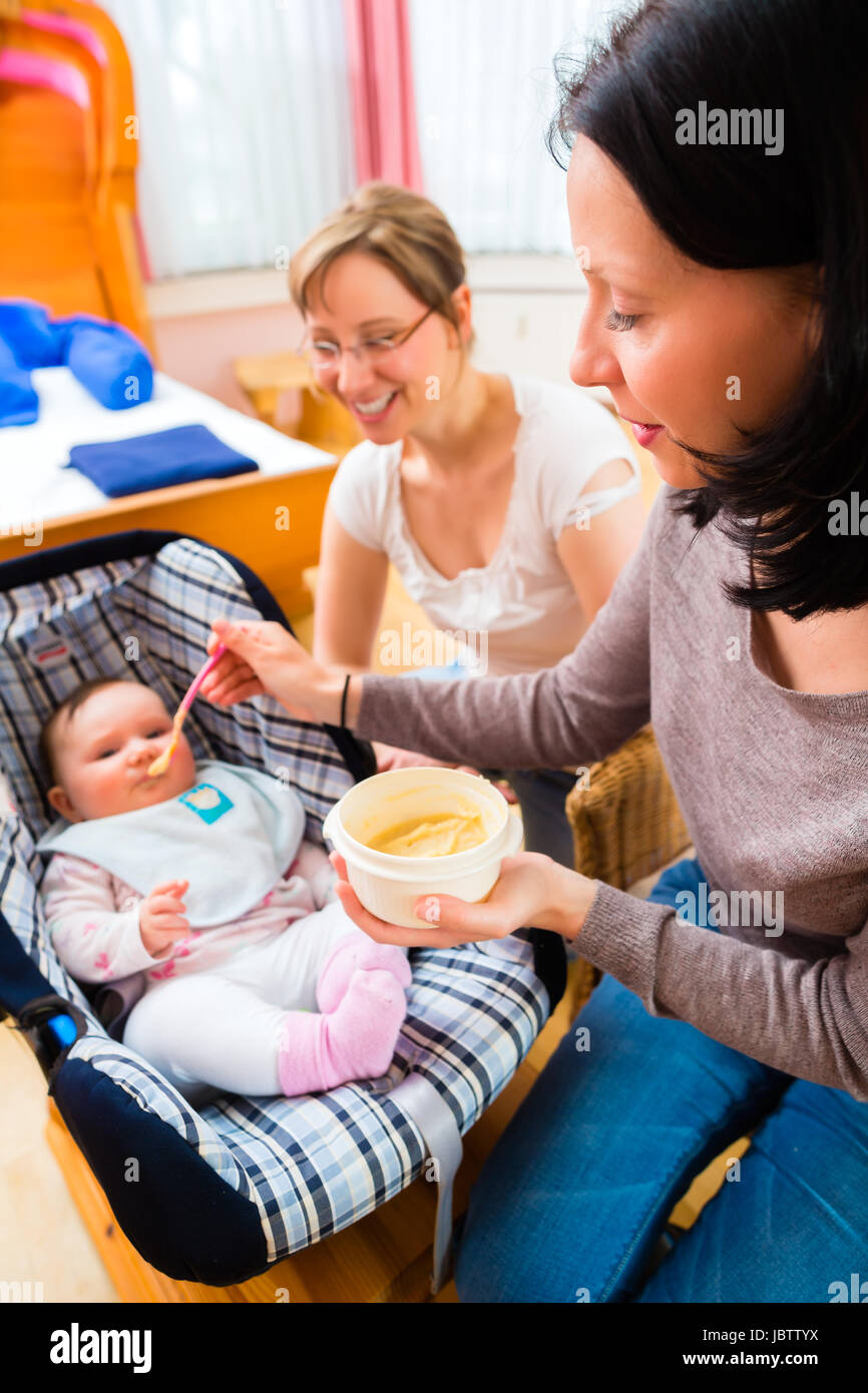 Mother feeding baby at midwife practice Stock Photo - Alamy