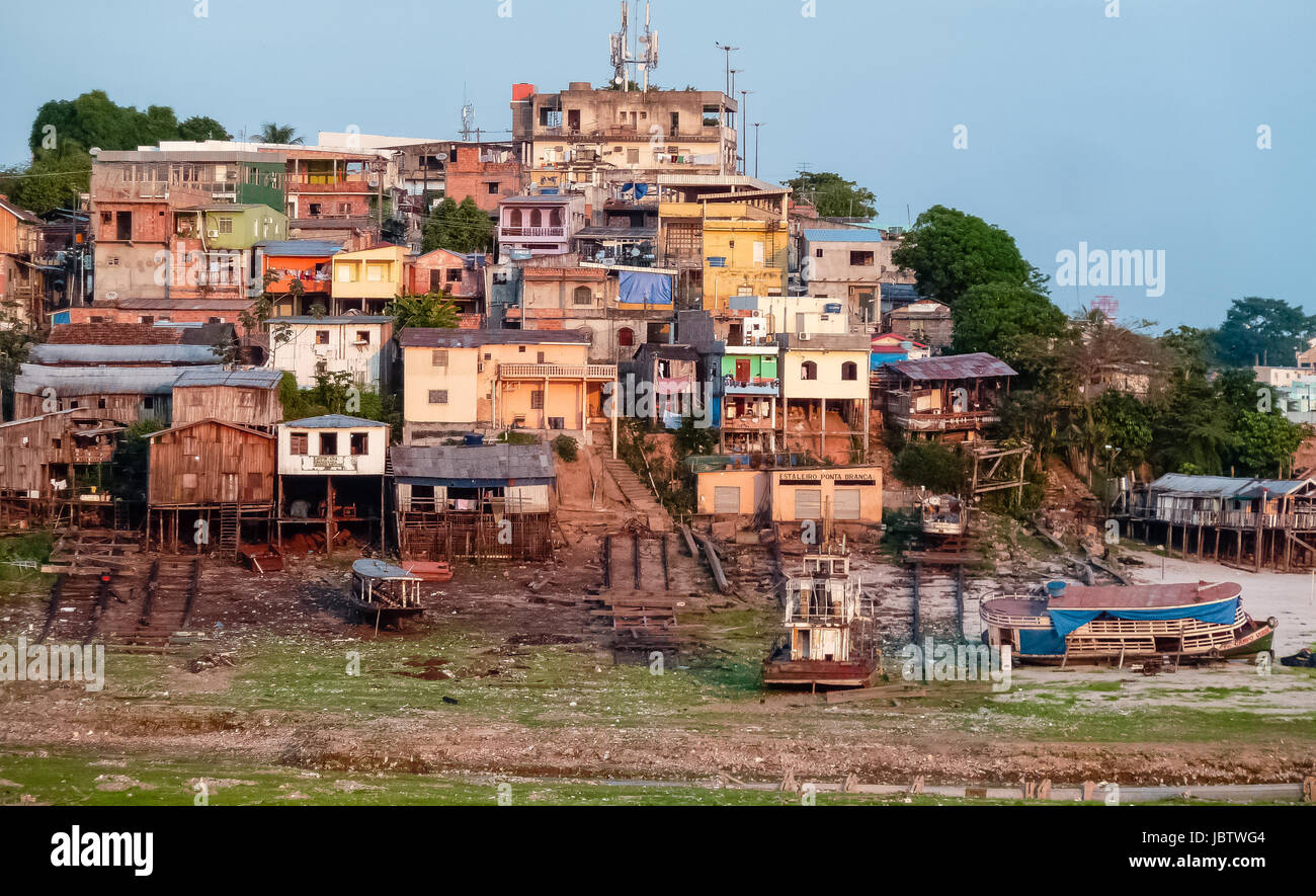 View of a favela at the Amazon riverbank near boat harbor, low tide, Manaus, Brazil Stock Photo