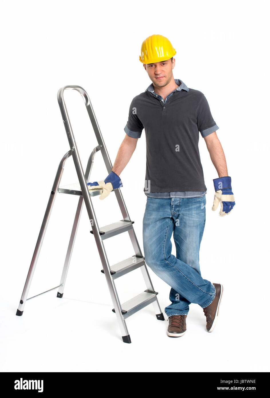 young man with hard hat and stepladder Stock Photo