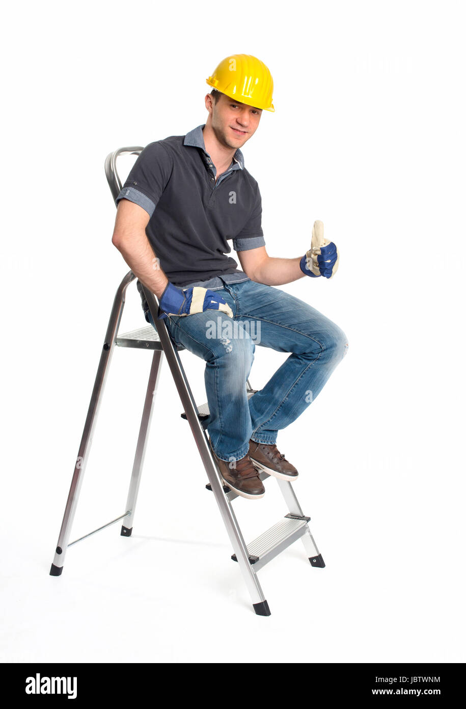 young man with hard hat and stepladder Stock Photo
