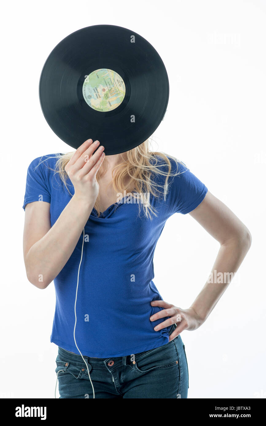 blonde girl hiding behind a record Stock Photo