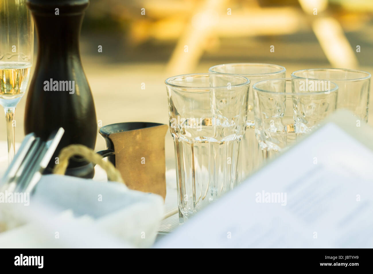 Ordering at a restaurant, glasses on the table Stock Photo