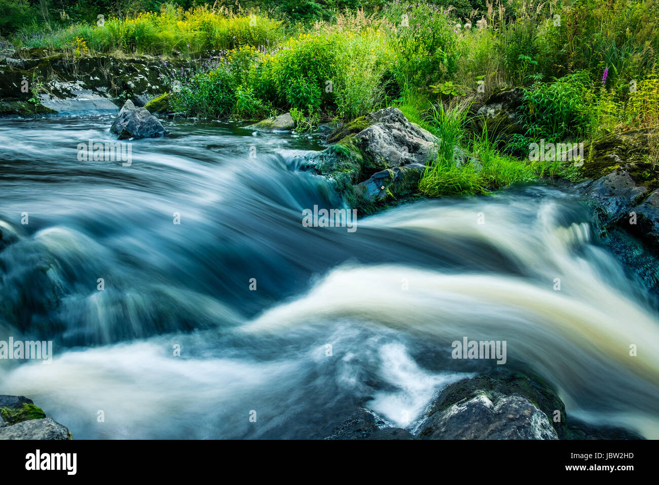 Landscape with flowing river and nice light at summer time Stock Photo