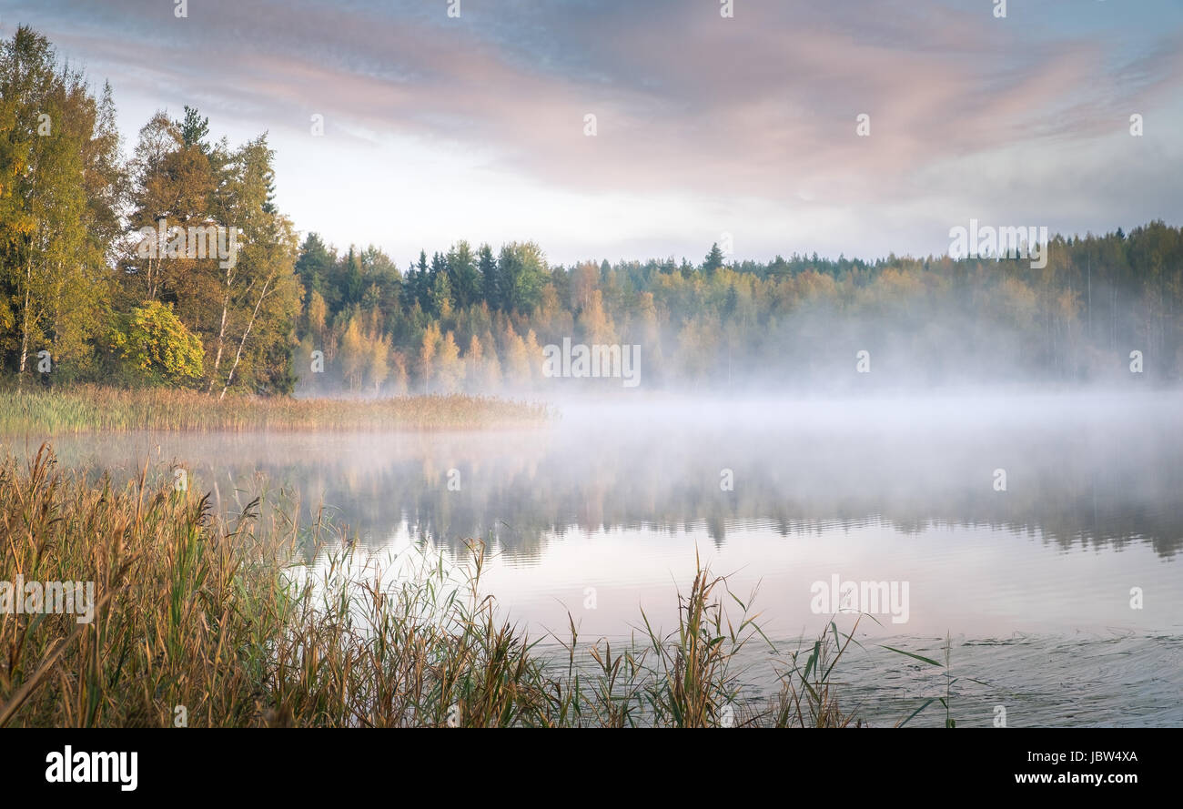 Scenic landscape with lake and fall colors at morning light Stock Photo