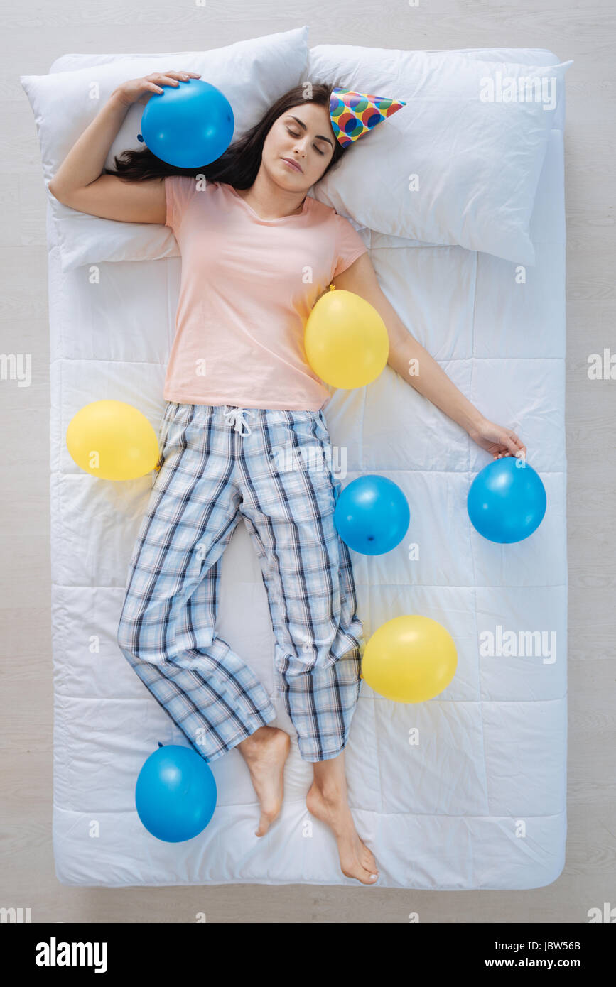 Joyful nice woman being surrounded by balloons Stock Photo