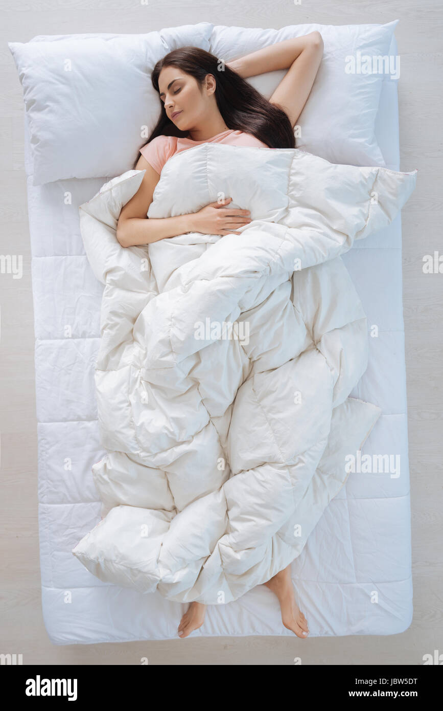 Nice young woman covering herself with the blanket Stock Photo Alamy