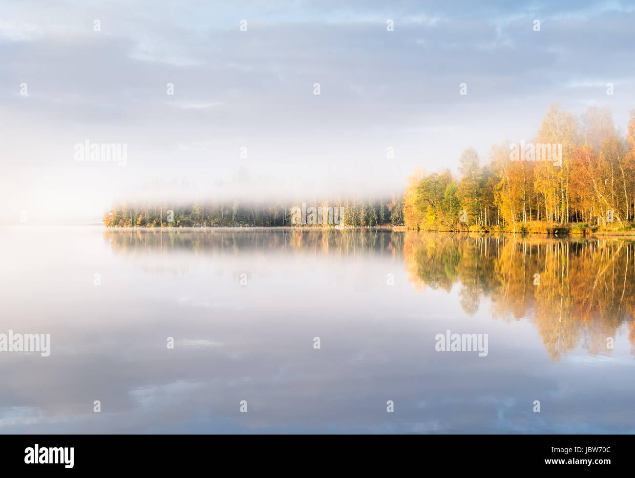 Scenic landscape with lake and fall colors at morning light Stock Photo