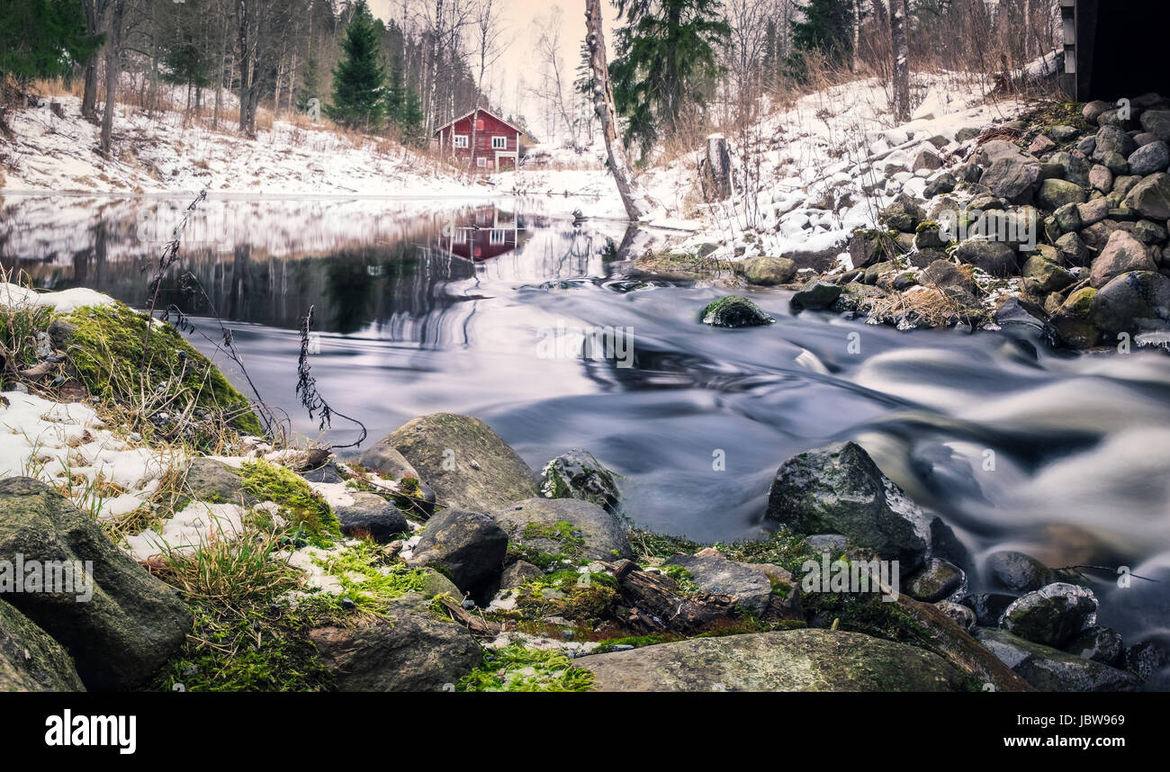 Scenic landscape with river and abandoned cottage at winter Stock Photo