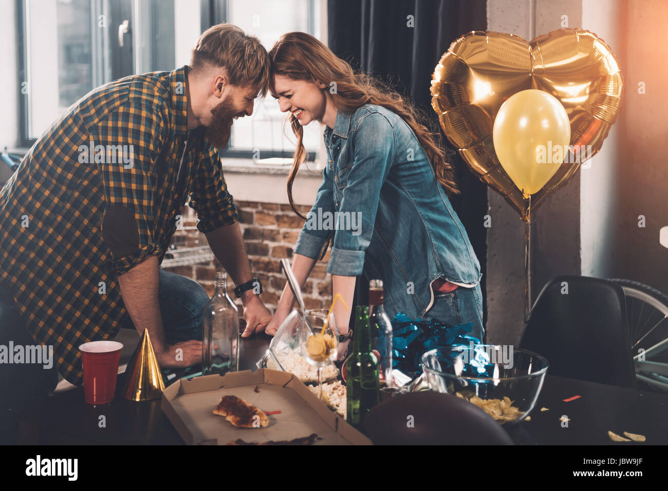 man and woman cleaning messy room after party Stock Photo